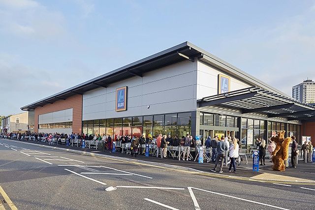 Customers queue around the block for the opening of Aldi