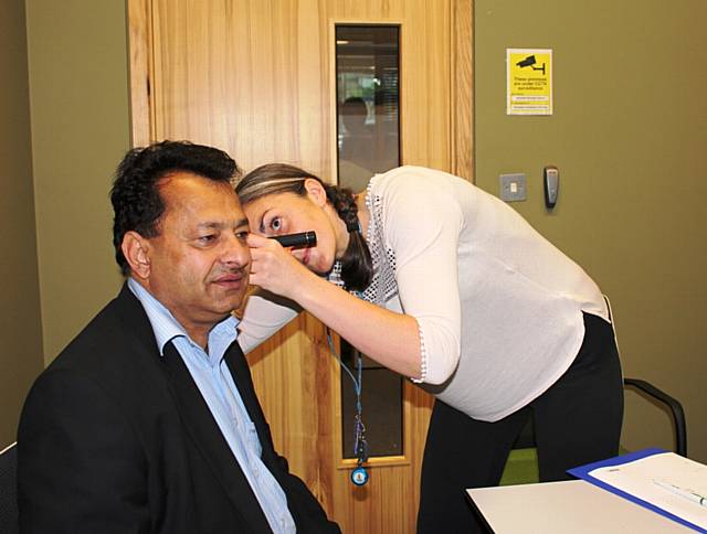 Councillor Iftikhar Ahmed has a hearing screening with audiologist Jill Butterworth