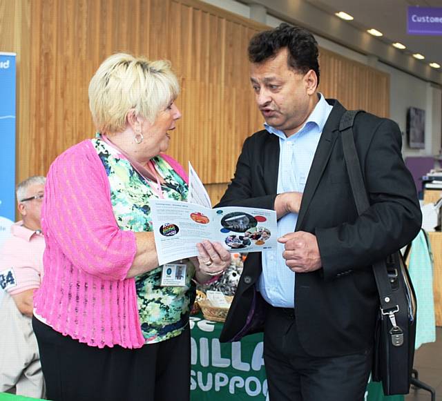 Pat McDonald talks Councillor Iftikhar Ahmed through the social activities on offer at the circle over 50s club
