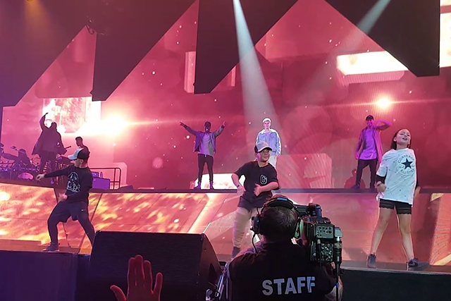 Max Wood (left) dancing on stage at Justin Bieber concert