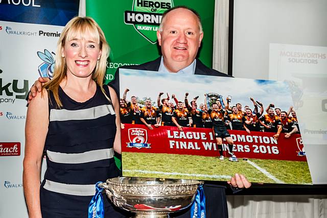 Jackie Meredith presents Hornets chairman Mark Wynn with a enlarged photograph of the team's celebrations following their triumph in Toulouse