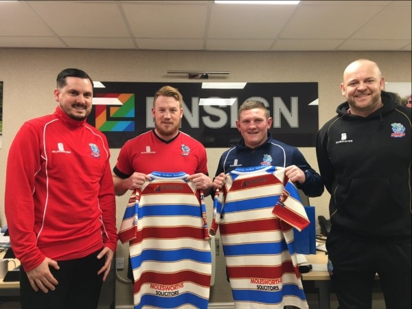 Analyst Steve Wordsworth, first team players Chris Riley and Jono Smith and head coach Alan Kilshaw show off the Ensign logo on the 2017 home shirt