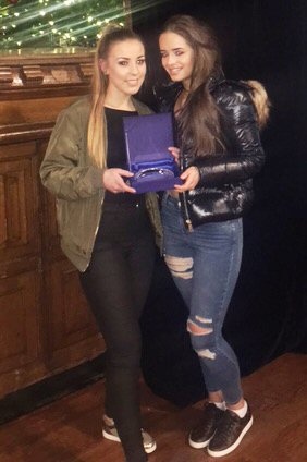 Ella Johnson and Sophie Cockton with Chloe's prize for the joint highest achiever in Health and Social Care