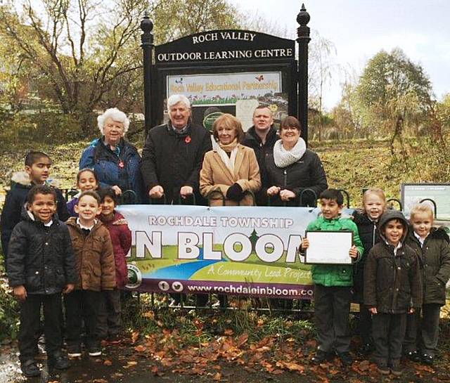 Councillors with children and teachers from Brimrod Primary School, holding their award from North West In Bloom