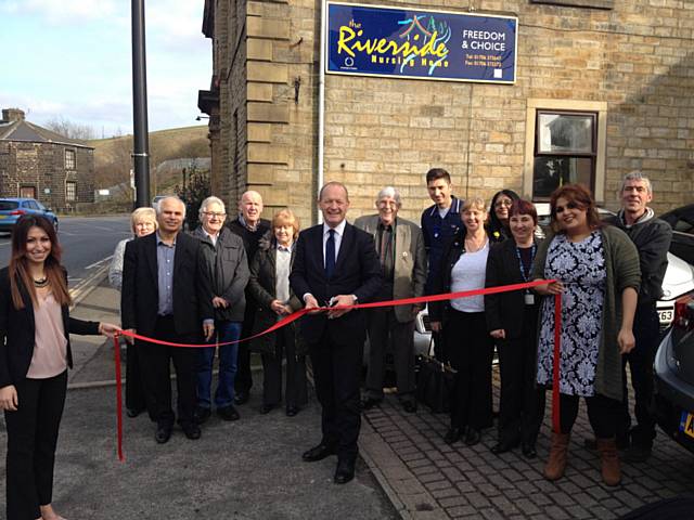 Simon Danczuk is joined by staff, residents and relatives as he cuts the ribbon to declare Riverside Nursing Home officially re-open