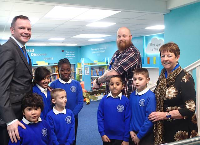 Headteacher Aelred Whelan, Chair of Governors Margaret Sutton and pupils, join local children’s author Adam Perrott for the official opening of the new library at St Peter’s Church of England Primary School 