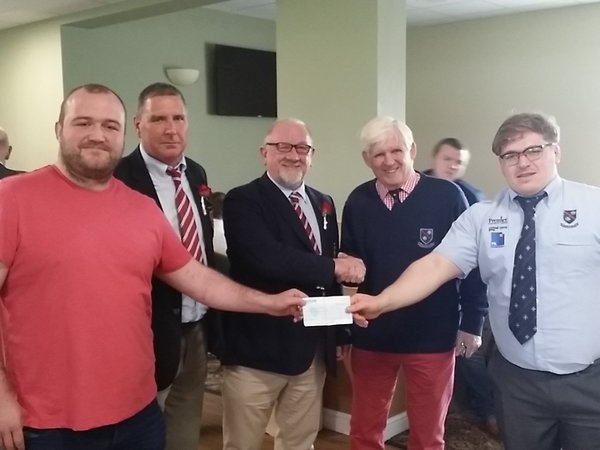 Rochdale RUFC club captain Tom Callaghan, Chairman Iain Coates and President Steve Helliwell present a cheque for £1000 to the Carlisle captain and president 