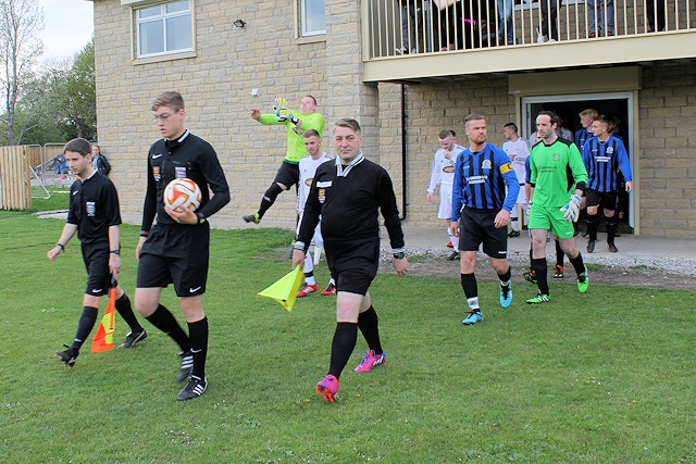 The officials lead the players out at Fox Park