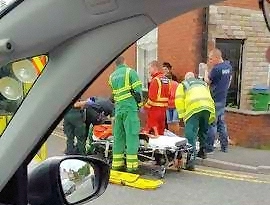 Paramedics treat the casualty at the scene of the accident