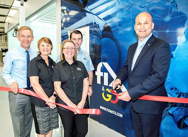Ian Pugh of Fix Auto UK cuts the ribbon declaring the latest Fix Auto Fix & Go express repair facility open for business with owners (from left) Phil and Wendy Ewbank with Managing Director Michelle Walker and VDA and Business Development Manager Lee Ewbank