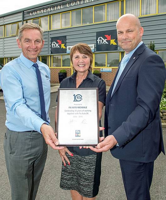 Ian Pugh, head of Fix Auto UK, presents Phil and Wendy Ewbank, owners of Fix Auto Rochdale, with their plaque after becoming the latest members of the network’s 10th Anniversary Club