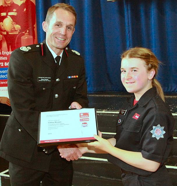 Cadet Chloe Brown receives her Cadet of the Year certificate from Assistant Chief Fire Officer Dave Russel
