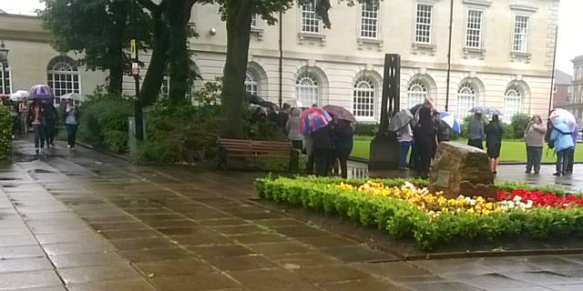 Rochdale Exchange Shopping Centre evacuated, staff congregated in the Memorial gardens in the rain