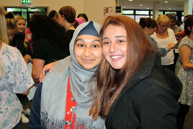 Husneara (left) celebrates her 12 GCSEs, including two A* and  eight A