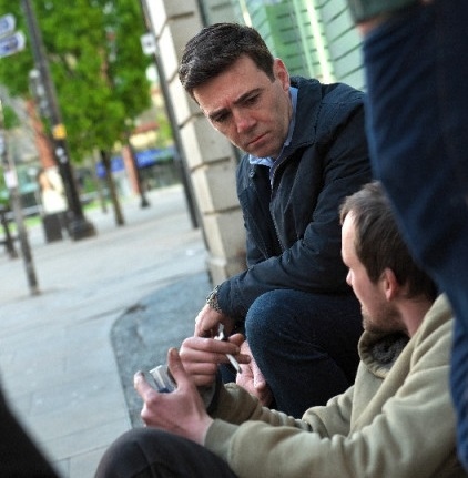 The Mayor of Greater Manchester Andy Burnham speaking to a homeless man