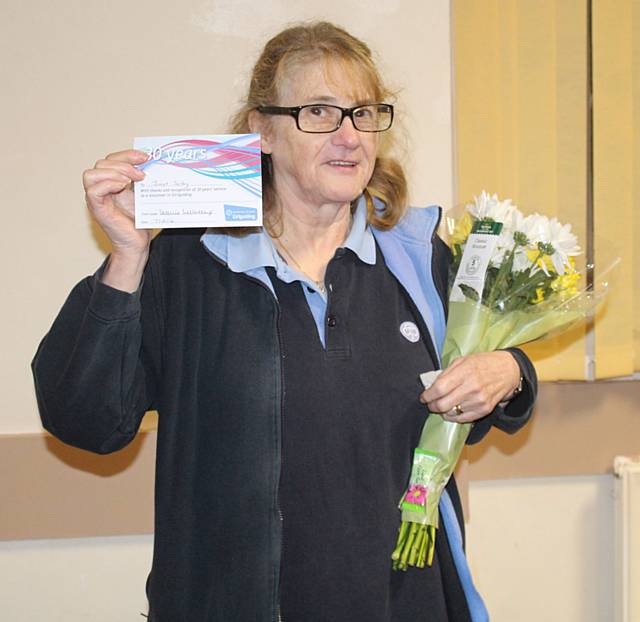 Janet Selby with her 30 years’ service certificate and flowers