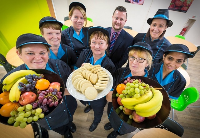 The catering team at Lowerplace Primary School in Rochdale celebrate with Headteacher Garry Johnson. (Left to right: Ellen Golden, Theresa Buckley, Lisa Hill, Marion Roberts, Garry Johnson, Christine Lancelott, Claire Carroll and Saika Ilyas)