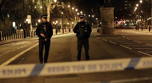 Two officers at a cordoned off area on the way to the Houses of Parliament in central London