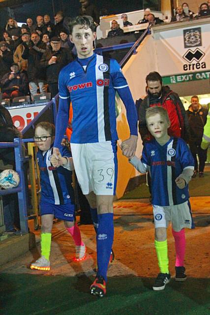 Joe Bunney leads mascots Harry and Henry out onto the pitch