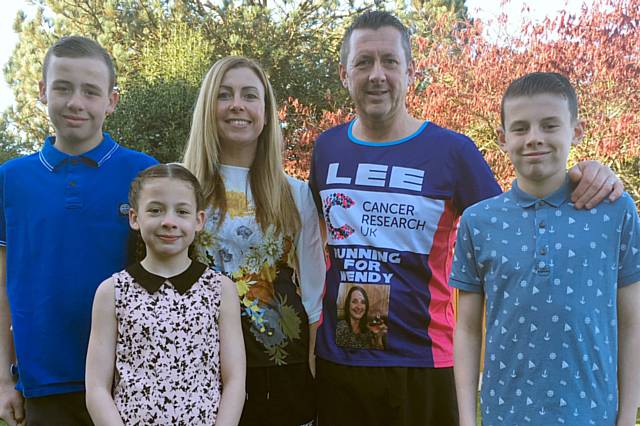 Lee Doherty in his CRUK running vest with wife Emma and children Joshua, 12, Megan, 8 and Rhys, 11.