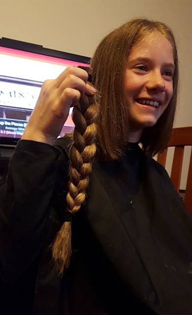 Jasmine with the plait that has gone to The Little Princess Trust to make wigs for a child with hair loss