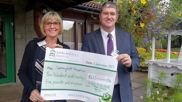 Councillor Chris Furlong presenting Julie Perry, Corporate Service Manager at Springhill Hospice with the cheque