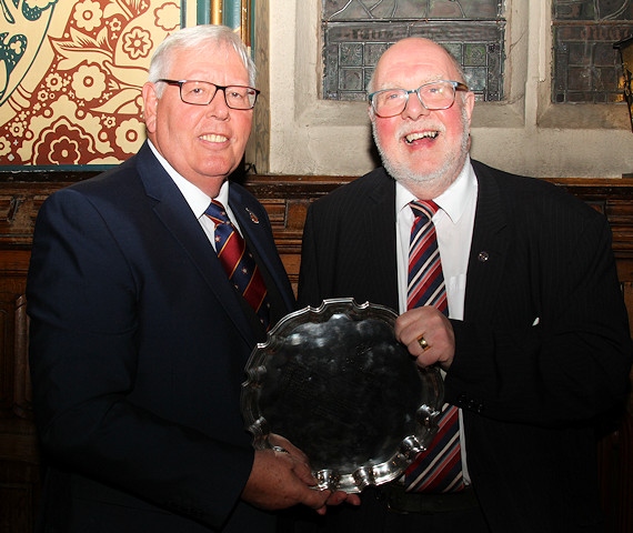 Last year's winner John Swinden presents the Man of Rochdale award to John Kay (right)