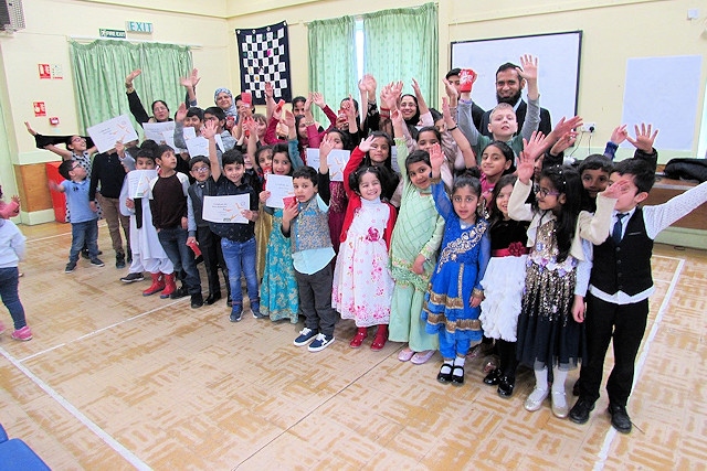 Children at Deeplish Community Centre proudly show off their certificates