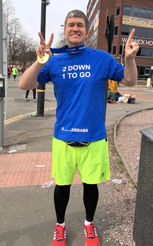 Councillor Furlong shows off his hard-earned medal following the Manchester Marathon