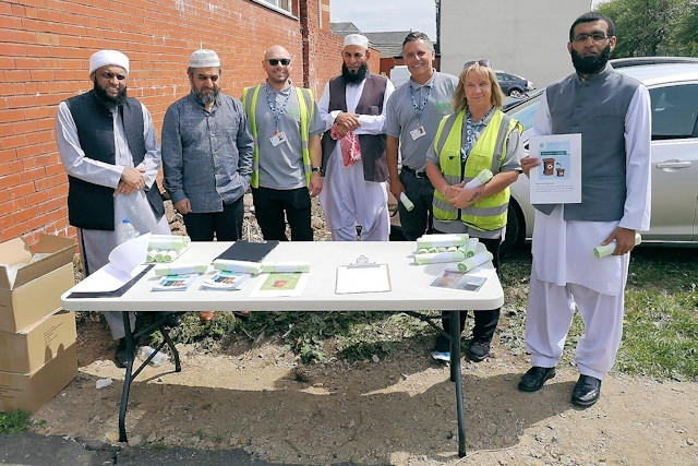 Rochdale Council's recycling team working with local community members and leaders outside Neeli Mosque