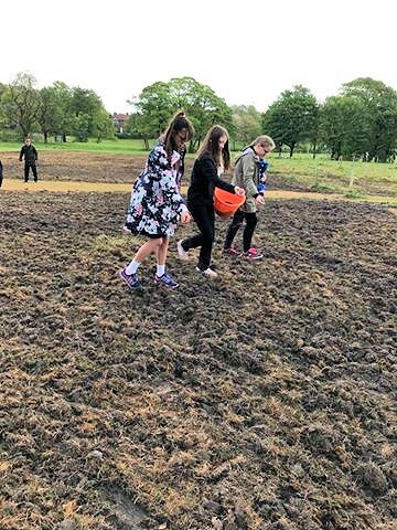 Students from Redwood Secondary School sowing wildflower seeds in Denehurst Park