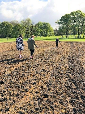 Students from Redwood Secondary School sowing wildflower seeds in Denehurst Park