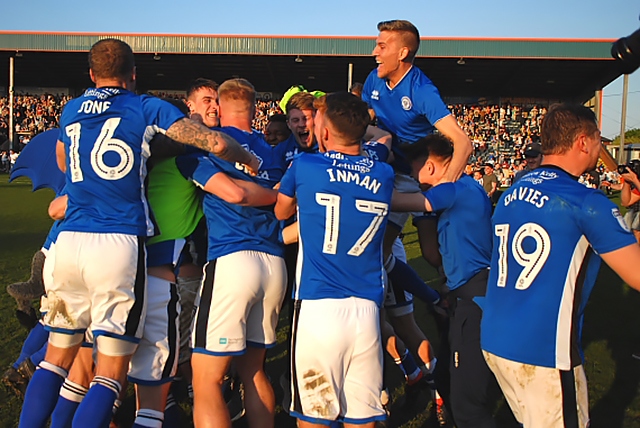 Rochdale players celebrate avoiding relegation