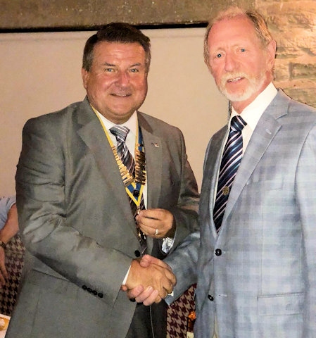Mike Goldrick receiving the president role from immediate past president Frank Coates