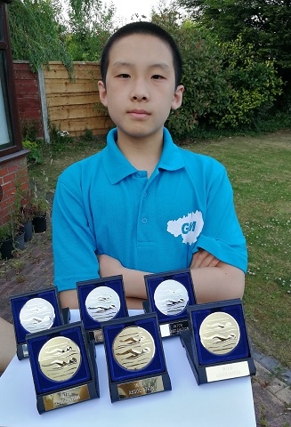 Xaunming Guo with his medals from the County Inter Association Swim Meet in June