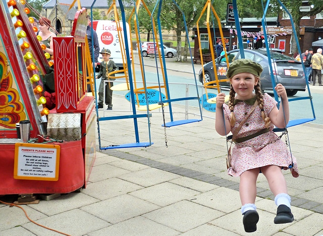 A girl in 1940s clothing on a carousel
