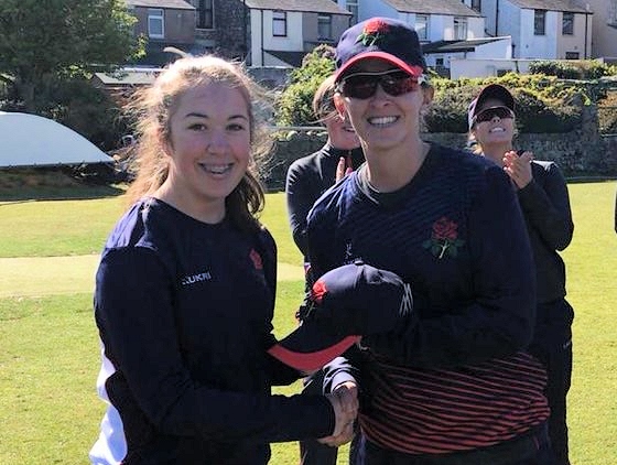 Olivia Thomas receives her Lancashire first team cap from Kate Cross