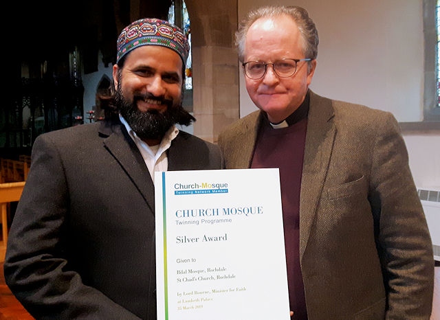 Revd Mark Coleman (right) with Imam Hassanat Ahmed (left) and their award for twinning St Chad's Parish Church with Bilal Mosque