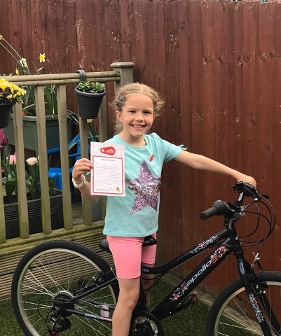 Mia Coley shows off her level one Bikeability certificate