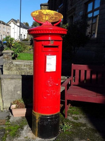 The enamel sign on the post box