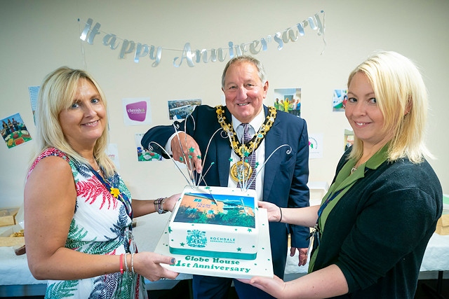 The Mayor helps cut the cake, celebrating the 21st birthday of Globe House, with (left) business centres manager Trudie Unsworth and assistant business centres manager Joanne Arnfield