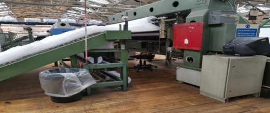 The quilting machine being used by the worker