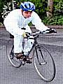 Jason Addy cycling wearing a full white protective overall