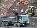 Asbestos factory rubble being moved