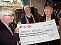 Paul Rowen and Sir Cyril present Maureen Cooper of Rochdale Childer with the cheque 