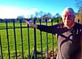Spotland resident Brian Penty beside the historic wrought iron fencing he wants saving