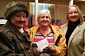 Councillor Carol Wardle and Beverley Place hand over a cheque for £1,500 to Christine Downham-Clark of Heywood Foodbank
