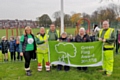 Councillors Susan Emmott and Carol Wardle with Sandra Trickett of Friends of Hopwood Park, Hopwood Community Primary School pupils and Council staff raising the flag at Hopwood Park for the first time 