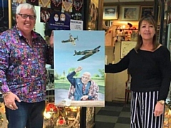 John Swinden and Lisa Haselden with her painting of Captain Tom Moore