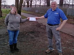 Rotary Heywood 2020 club secretary Edwin Partridge presents a cheque to Denise Dawson, receiving on behalf of 14th Heywood (Woodland) Guides, 7th Heywood (St. George's) Rainbows and 4th Ravenscroft Scouts